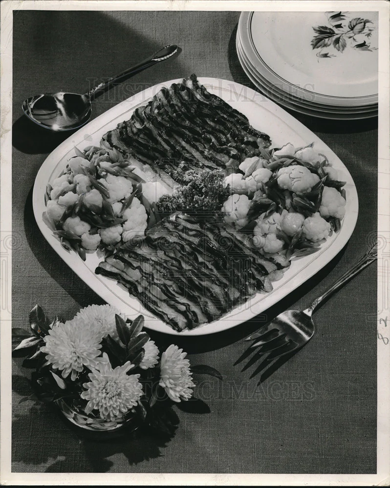 Press Photo Bacon served with two garden vegetables
