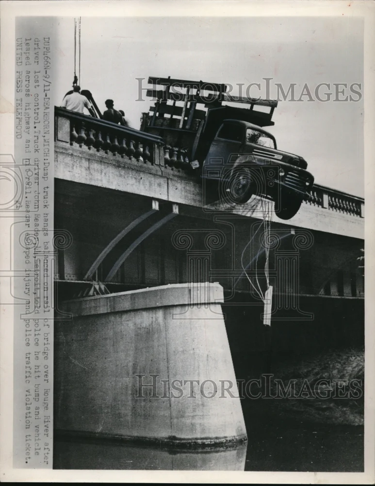 1952 Press Photo A dump truck hangs on a rail of a bridge over Rouge River