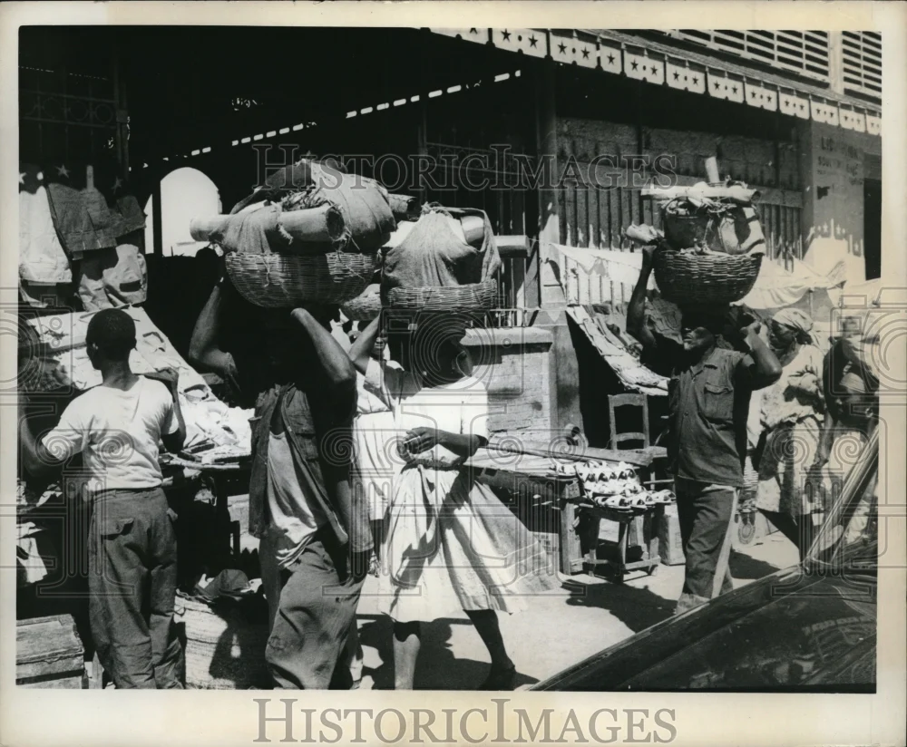 1963 Media Photo Natives carrying baskets of wares in Port-Au-Prince, Haiti