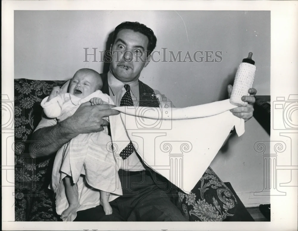 1948 Press Photo Gene Pertine Also Known As Butch Changing A Crying Baby