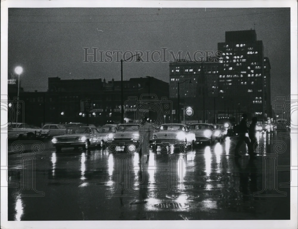 1963 Press Photo Darkness sets in on a rainy day lights in office building are