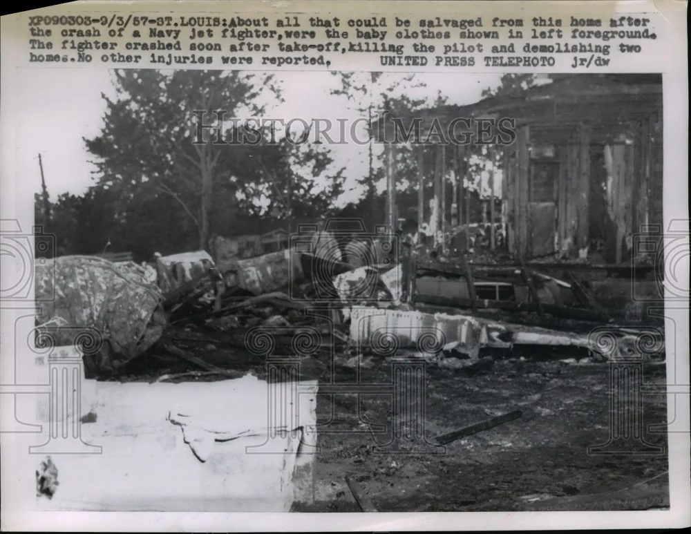 1957 Press Photo Wreckage of a jet fighter crashing into several houses