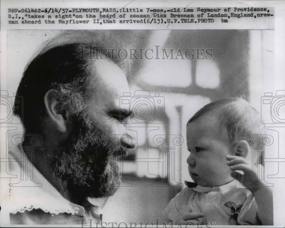 1957 Press Photo Sailor Dick Brennan Holds Baby Leo Seymour - nee25417