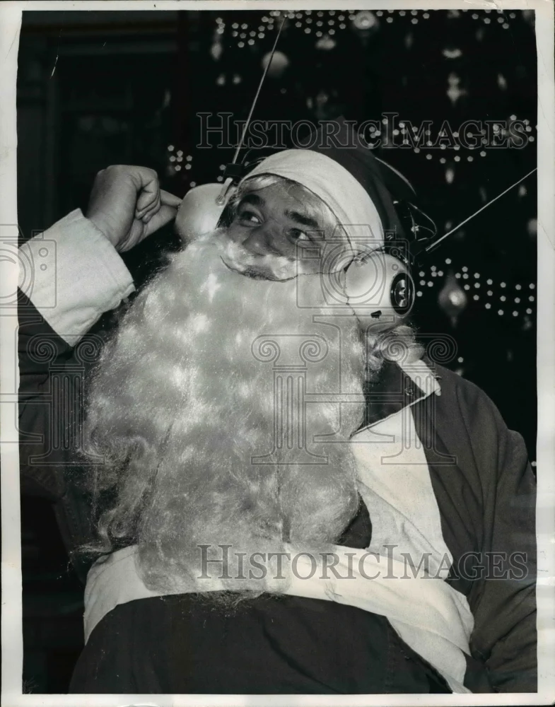 1969 Press Photo Santa Claus listens for latest weather report on headset