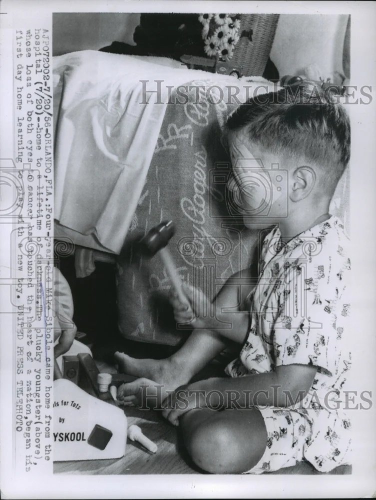 1956 Press Photo Mike Sibole learning to play with new toys with blindness