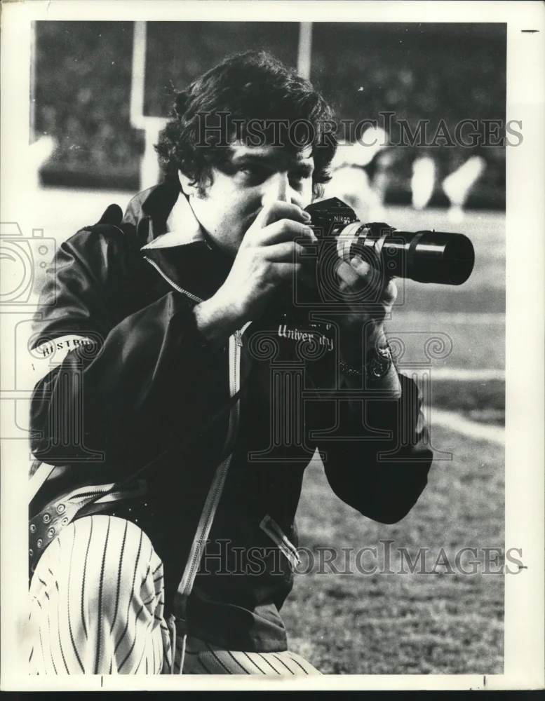1972 Press Photo Photographer Terry Friedman taking a picture at a football game
