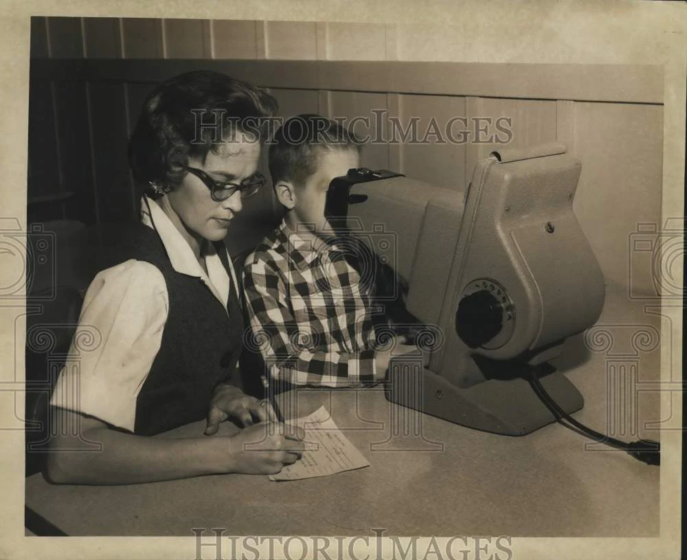 1967 Press Photo Mrs. Joyce Burkhart marks eye exam result of Chris Patterson