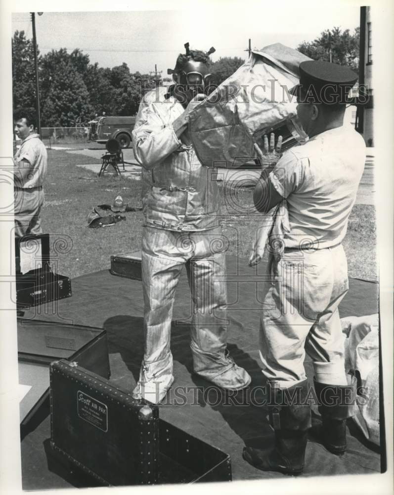 1961 Press Photo Jack Kieffer helps Lt. Henry Engelbracht - Flame Safety Suit