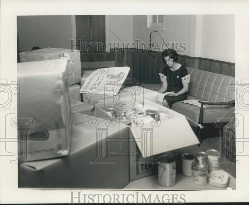 1966 Press Photo Mrs. Sercovich reads a letter as boxes of food are being packed