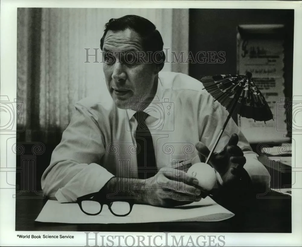 1968 Press Photo John Healy with a paper parasol stuck in a plastic 8-ball