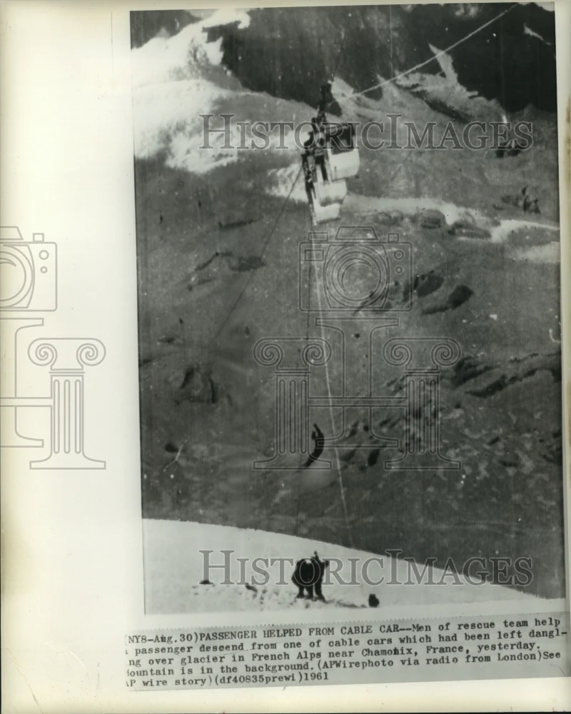 1961 Press Photo Rescue team help passenger descend from cable car in the Alps
