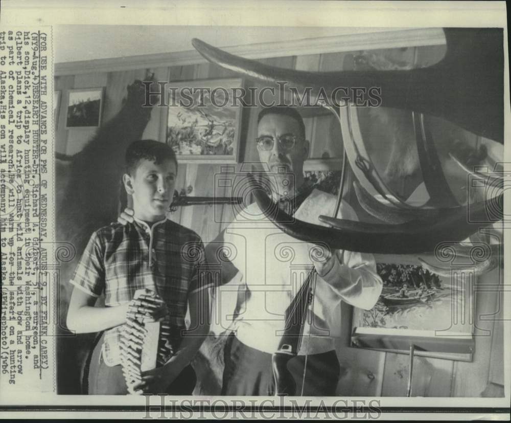 1967 Press Photo Dr. Herbert Gilbert & son Dick, display hunting equipment
